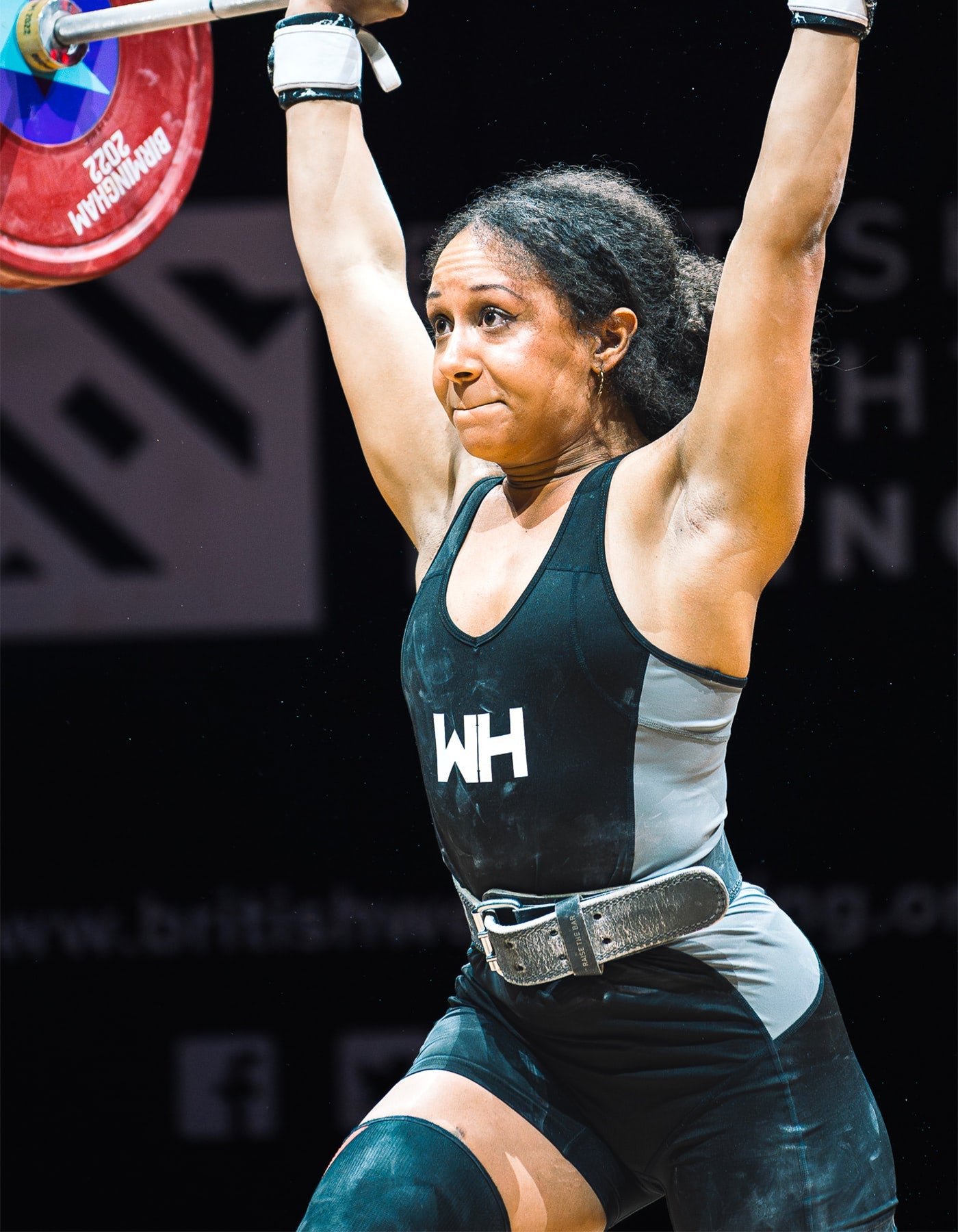 Zoe Smith wearing WH singlet in competition, recovering from jerk